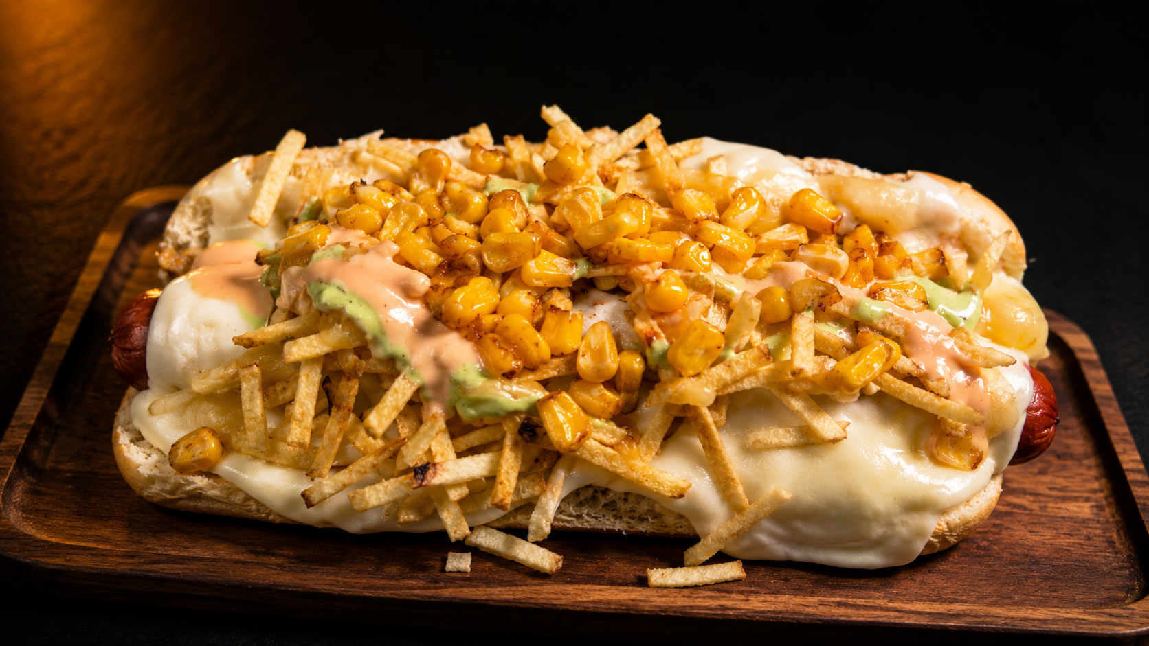 El Perro Callejero — Colombian loaded hot dog with melted cheese, corn, crispy potato sticks and house sauces